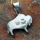 Handcrafted sterling silver turquoise buffalo inlay pendant by Evangie David, featuring a traditional buffalo design; artisan and Sterling Silver stamp.