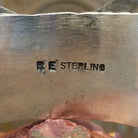 Close-up of the artisan's stamped signature.