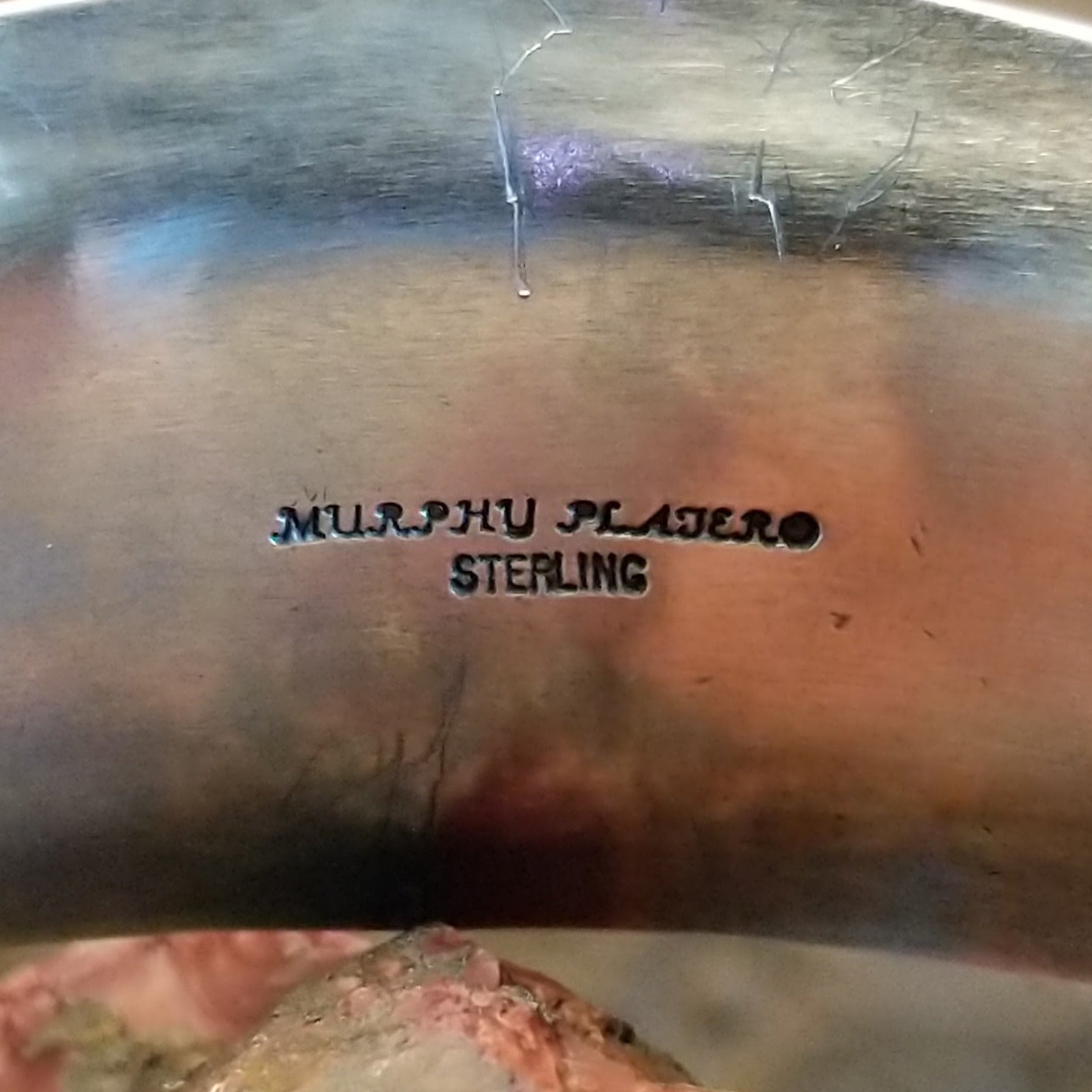 Close-up of the artisan's stamped signature.