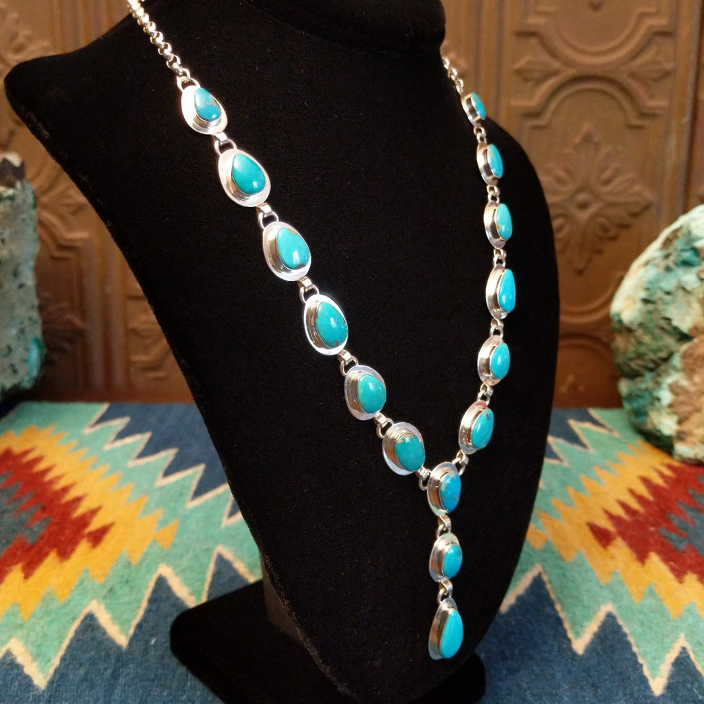 Turquoise set in cabochon sterling silver settings creating a drop effect.