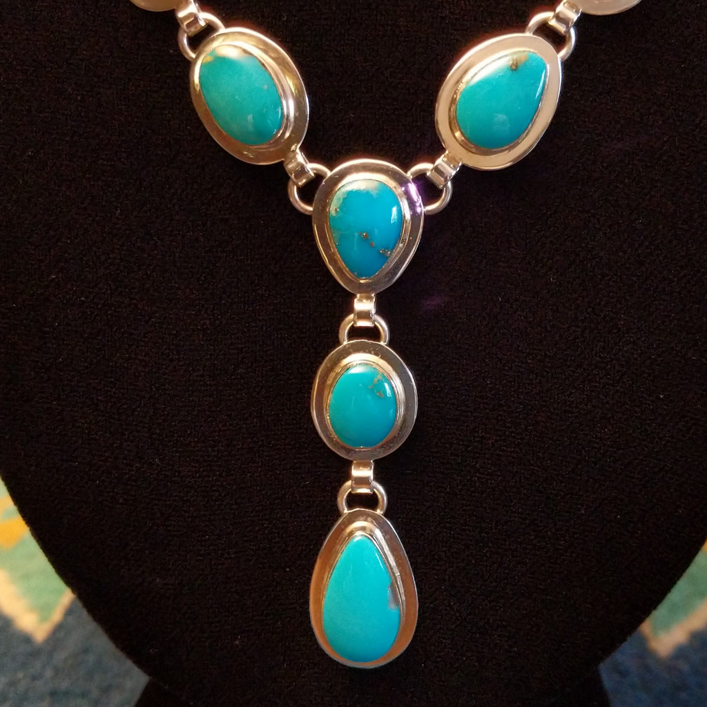 Turquoise set in cabochon sterling silver settings creating a drop effect.