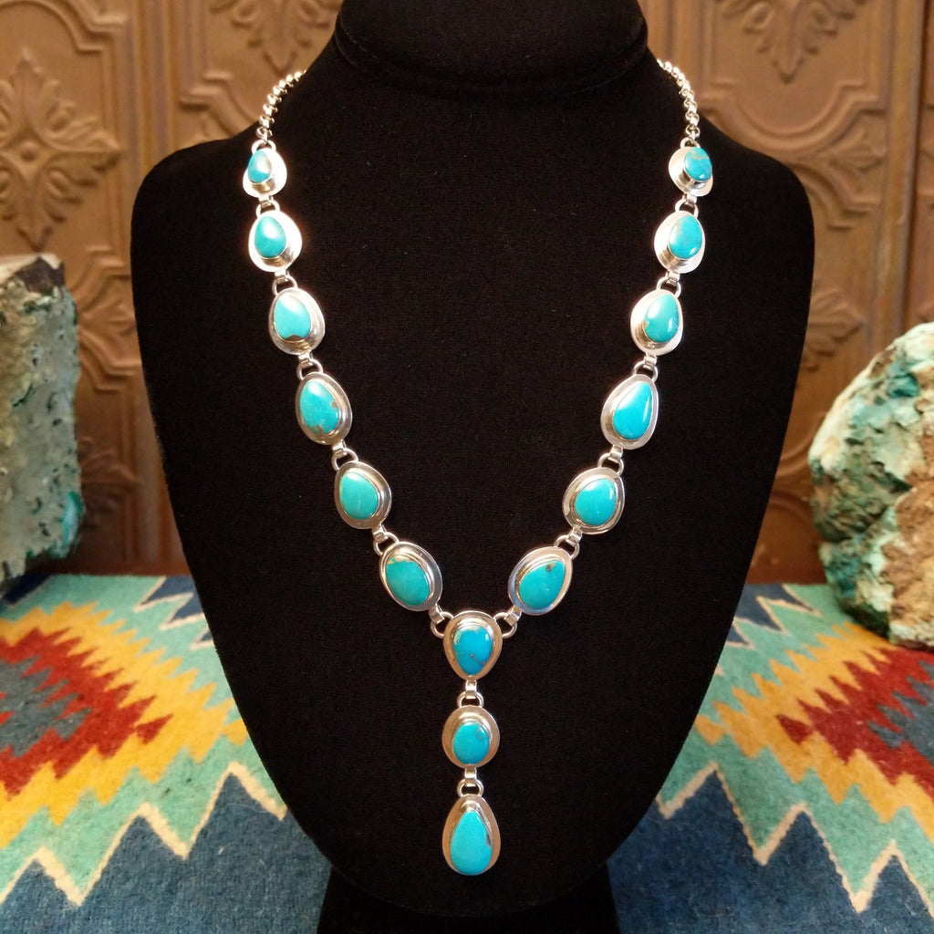 Turquoise set in cabochon sterling silver settings creating a drop effect.