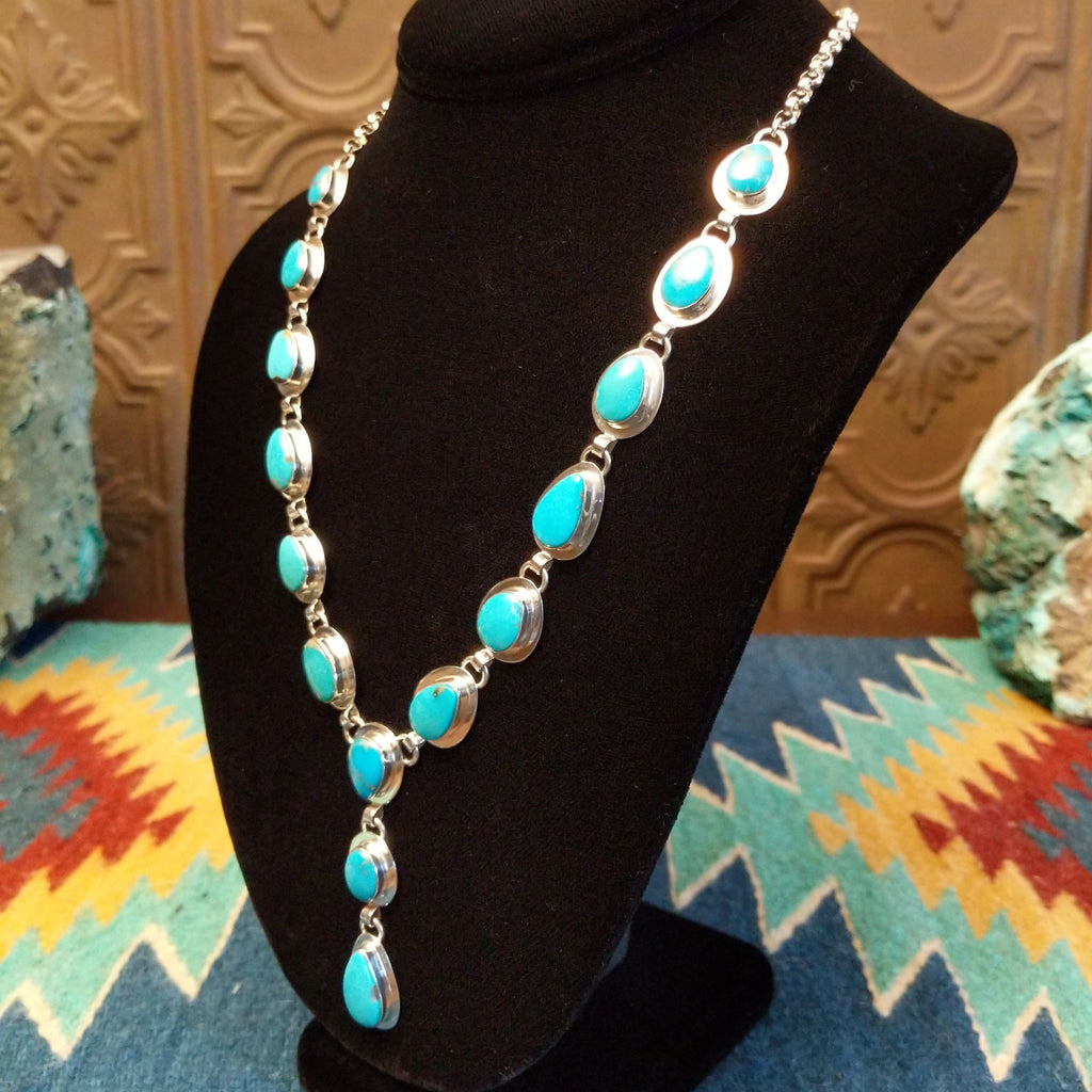 Turquoise set in cabochon sterling silver settings creating a drop effect.