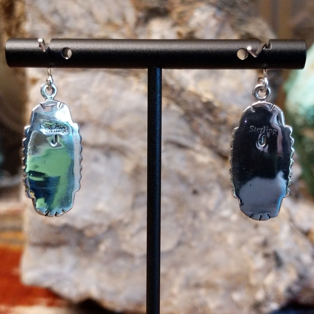 The back of the earrings feature the artisan's stamped initial.