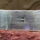 Close-up of the artisan's stamped signature.