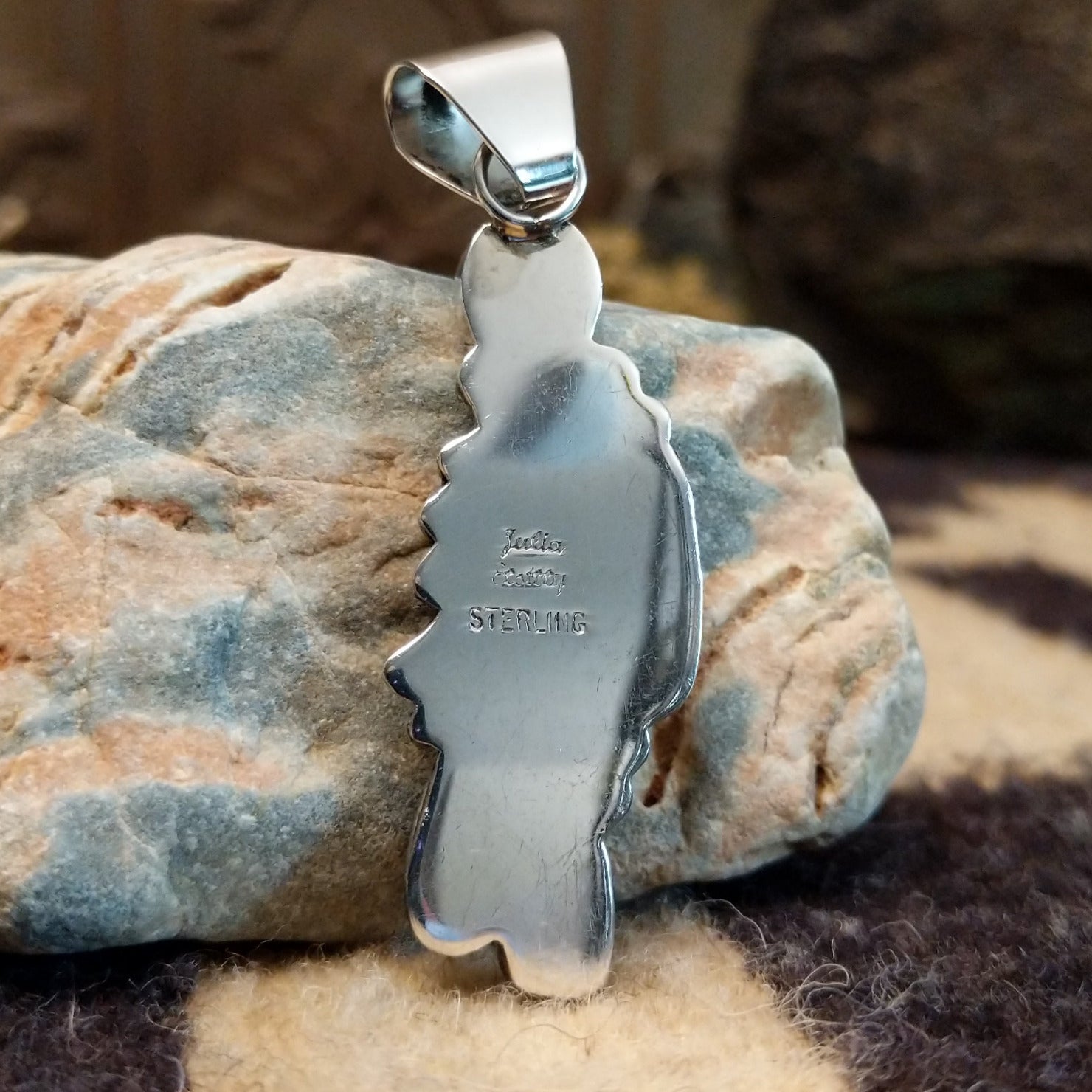 Close-up of the artisan's stamped signature.