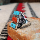 Turquoise and coral silver ring by Pauline Nelson with stamped arrow designs.