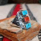Turquoise and coral silver ring by Pauline Nelson with stamped arrow designs.