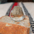Turquoise and coral silver ring by Pauline Nelson with stamped arrow designs.