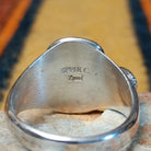 Turquoise & Coral Snake Ring by Effie Calavaza featuring turquoise and coral stones, a decorative silver snake motif with turquoise accents, sawtooth bezels, and a polished silver band; artisan and tribe stamp.