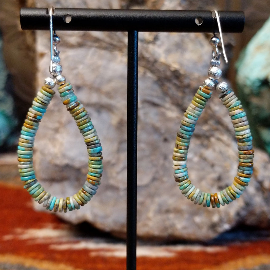 Turquoise beaded onto the sterling silver wire creating dangle earrings.
