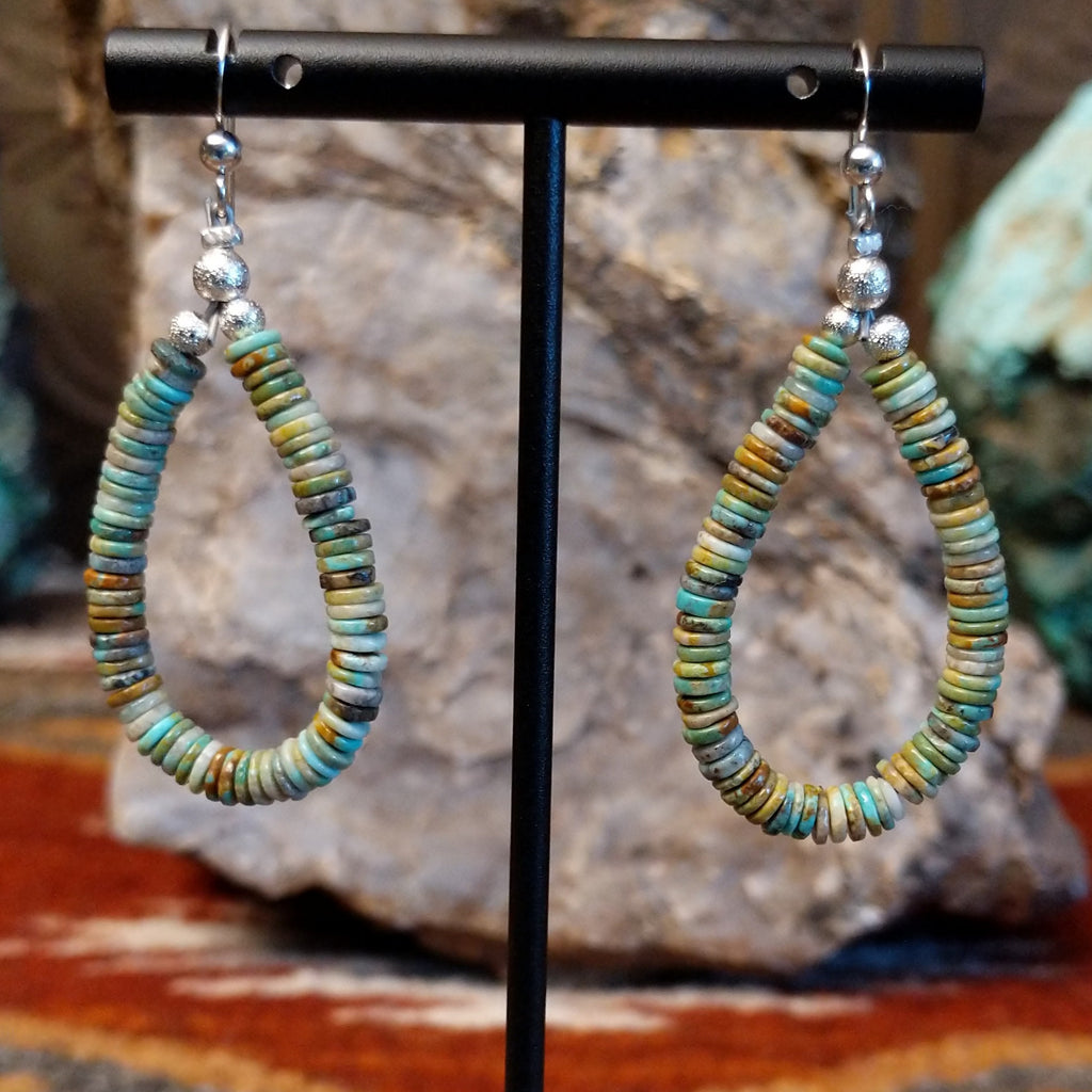 Turquoise beaded onto the sterling silver wire creating dangle earrings.