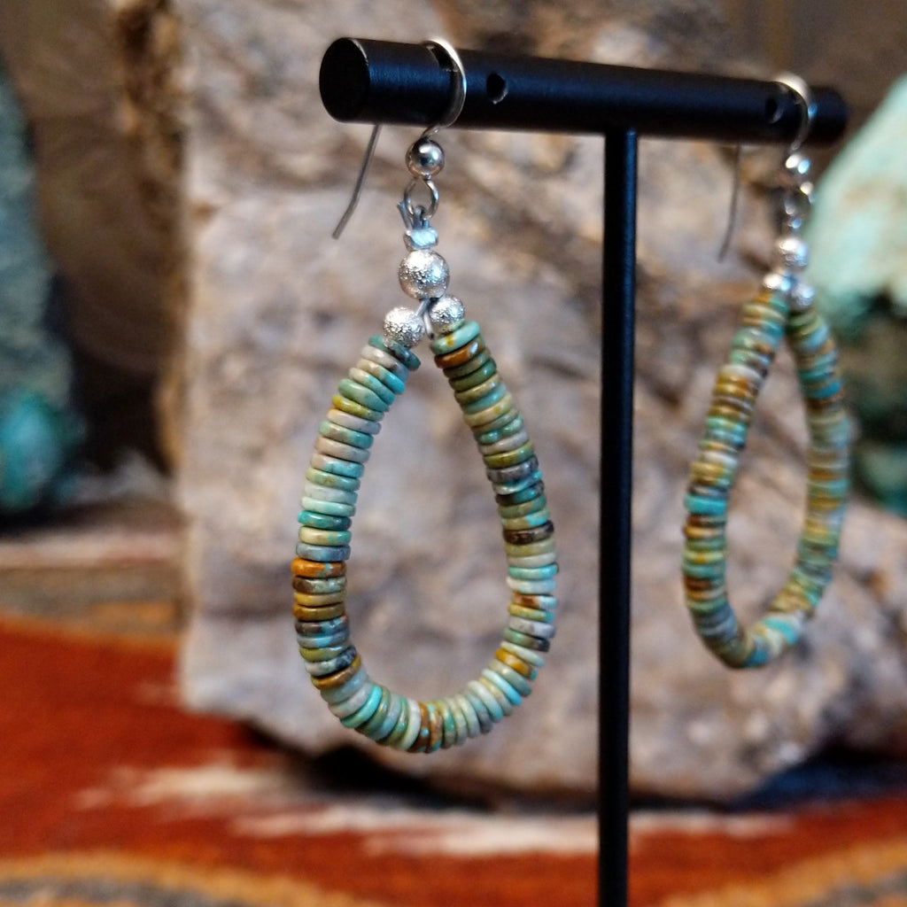 Turquoise beaded onto the sterling silver wire creating dangle earrings.