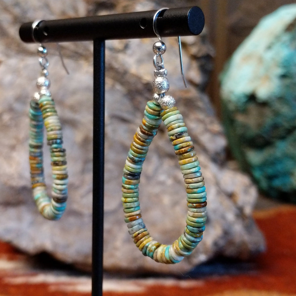 Turquoise beaded onto the sterling silver wire creating dangle earrings.
