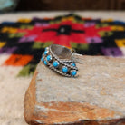 Turquoise dot hoop earrings by Chester Charley with twisted silver borders.