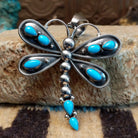 Silver dragonfly pendant with turquoise stones by Darrin Livingston. Front view. 