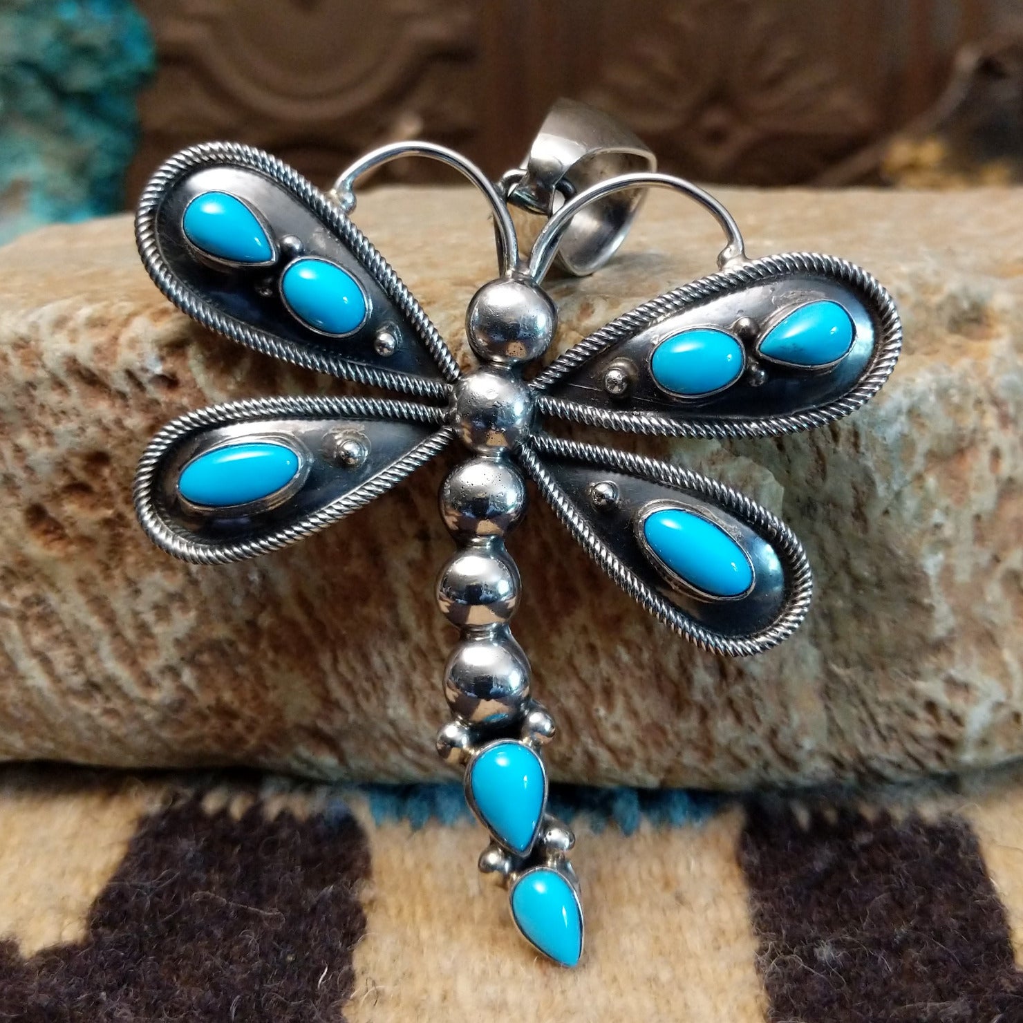 Silver dragonfly pendant with turquoise stones by Darrin Livingston. Front view. 