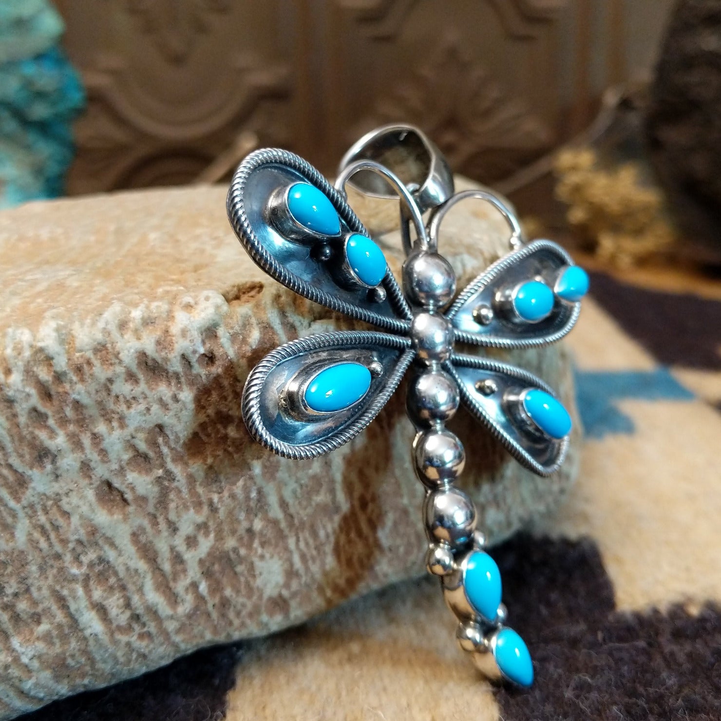 Silver dragonfly pendant with turquoise stones by Darrin Livingston. Side view. 