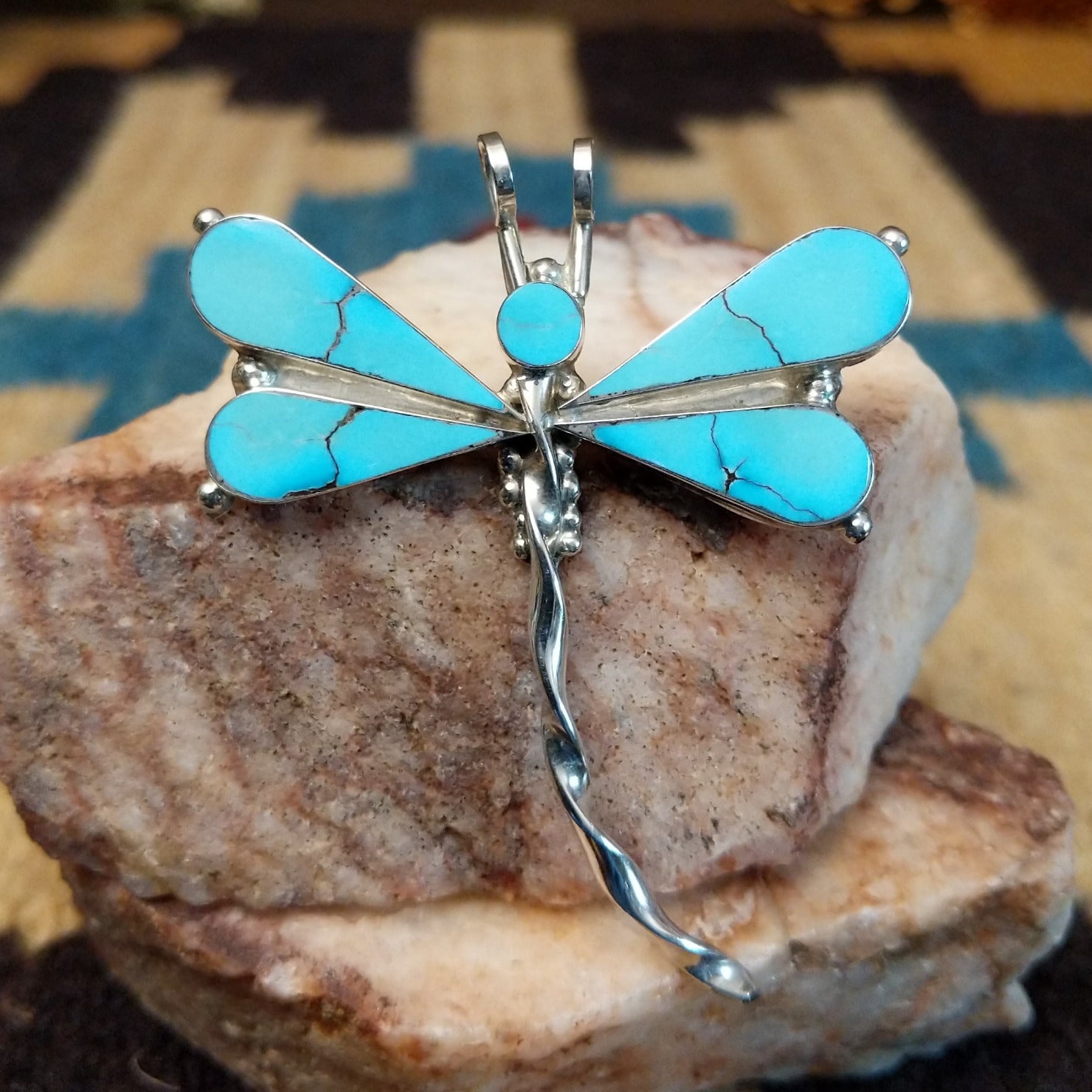 Sterling silver dragonfly pendant with turquoise set in the wings.