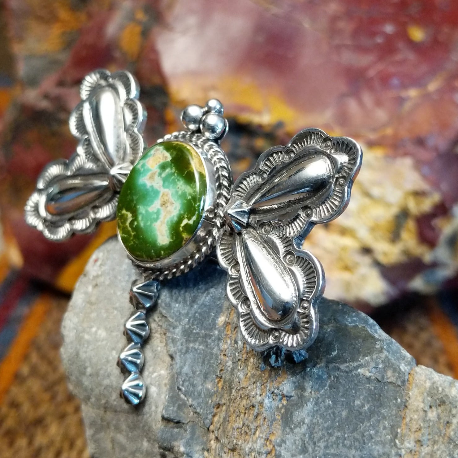 Sterling silver dragonfly pendant with twisted rope detailing and turquoise set in the bezel.