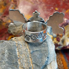 The band features floral stamping.