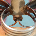 Turquoise Dragonfly Ring by Tim Yazzie featuring two turquoise stones set in Sterling Silver with polished wings, curled antennae, and dimensional silver accents; artisan stamp.