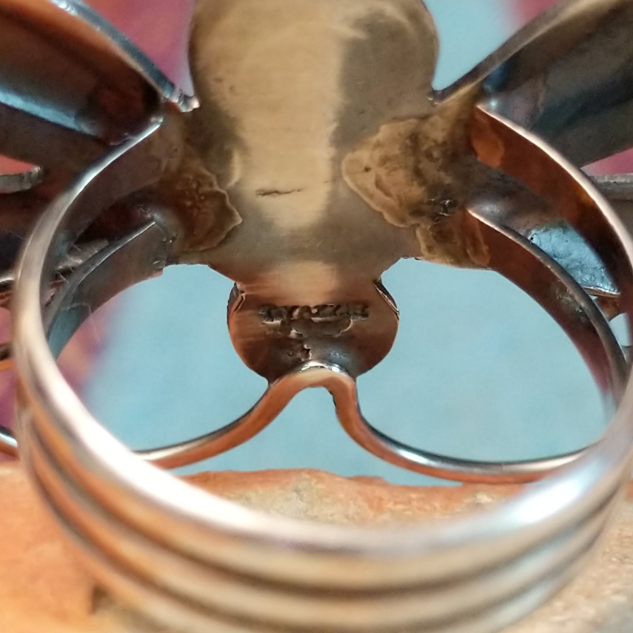 Turquoise Dragonfly Ring by Tim Yazzie featuring two turquoise stones set in Sterling Silver with polished wings, curled antennae, and dimensional silver accents; artisan stamp.