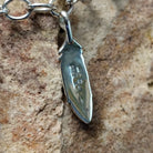 Turquoise feather charm bracelet by Elgin Tom with sterling silver feathers and natural turquoise accents; artisan and Sterling Silver stamp.