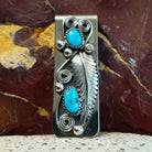 Turquoise feather money clip with two turquoise stones in silver bezels.
