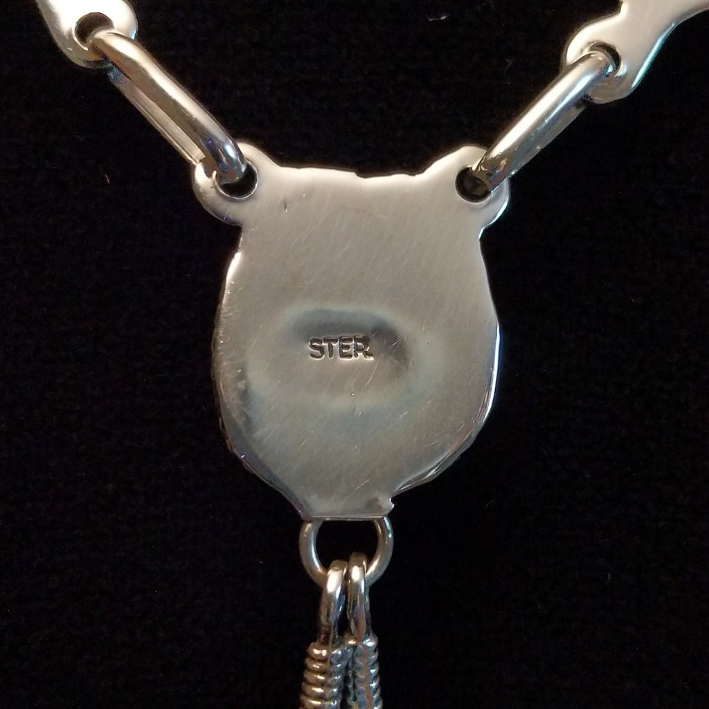 The sterling silver stamp on the back of the pendant.