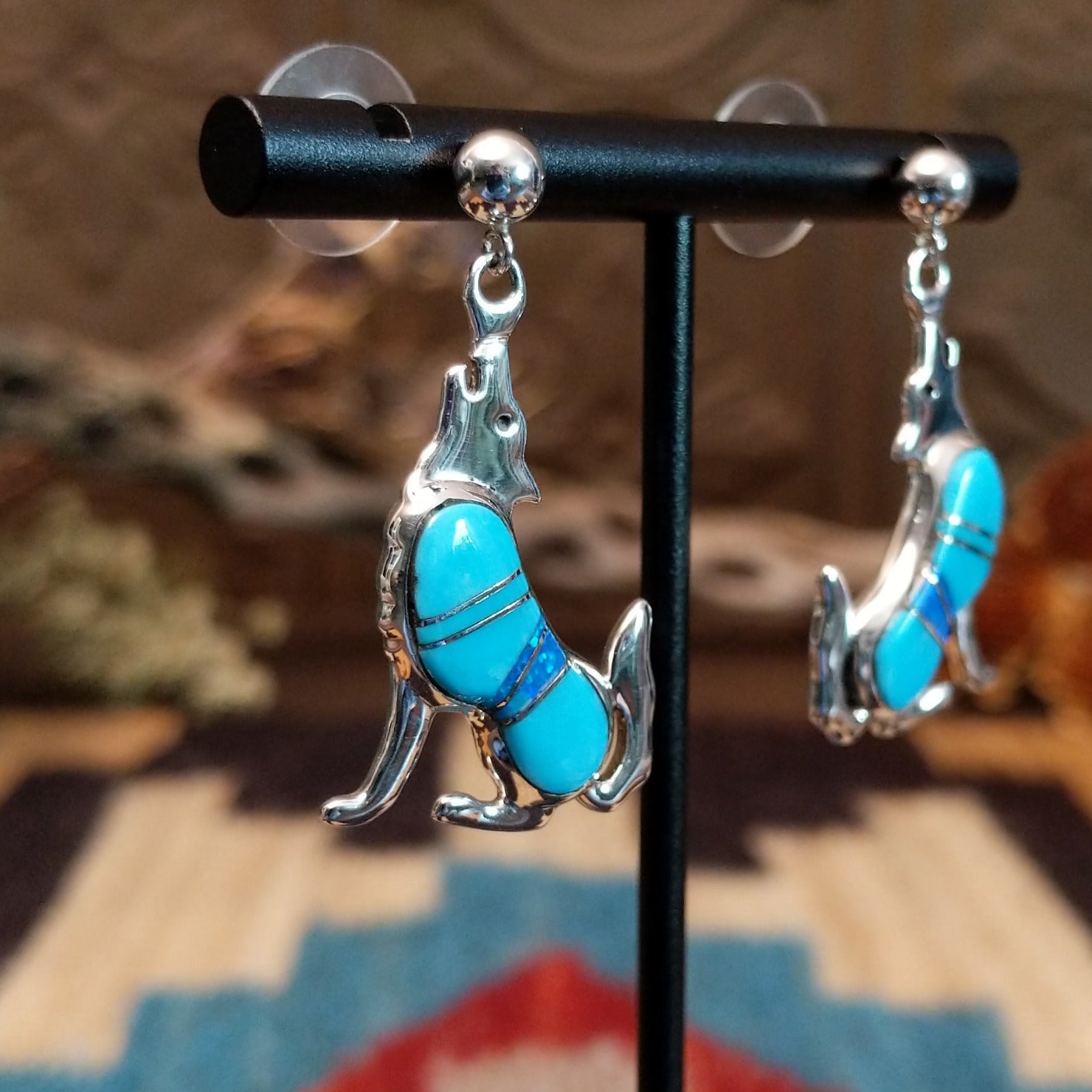 Sterling silver coyote earrings with turquoise set in the bezels.