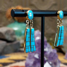 14k gold dangle earrings by Tom Billy with turquoise inlay and dual tapered drops.