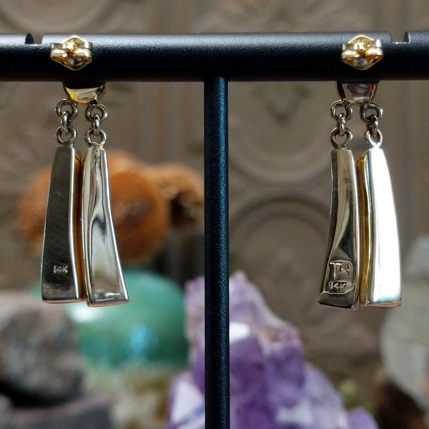 Close up of artist's stamped signature and 14K indicating 14 karat gold construction.