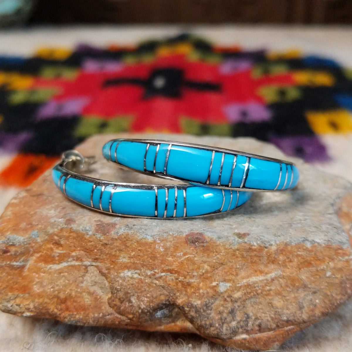 Turquoise inlay hoop earrings by Keme Peina with silver line details.