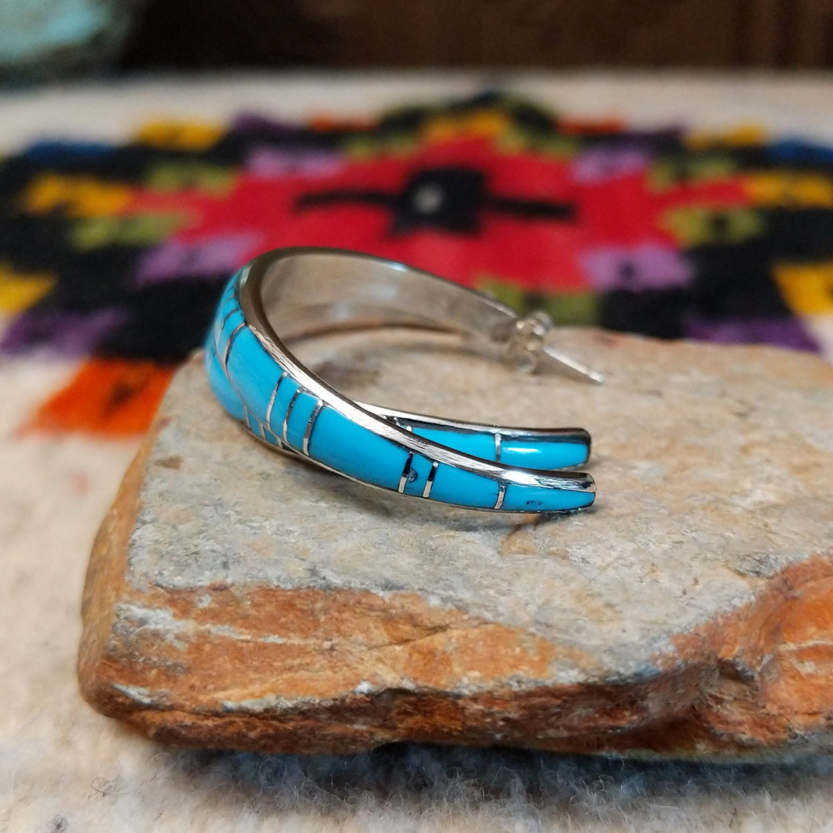Turquoise inlay hoop earrings by Keme Peina with silver line details.