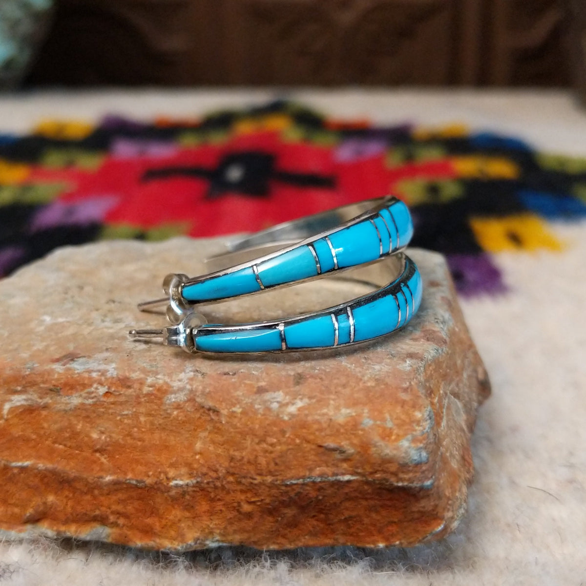 Turquoise inlay hoop earrings by Keme Peina with silver line details.