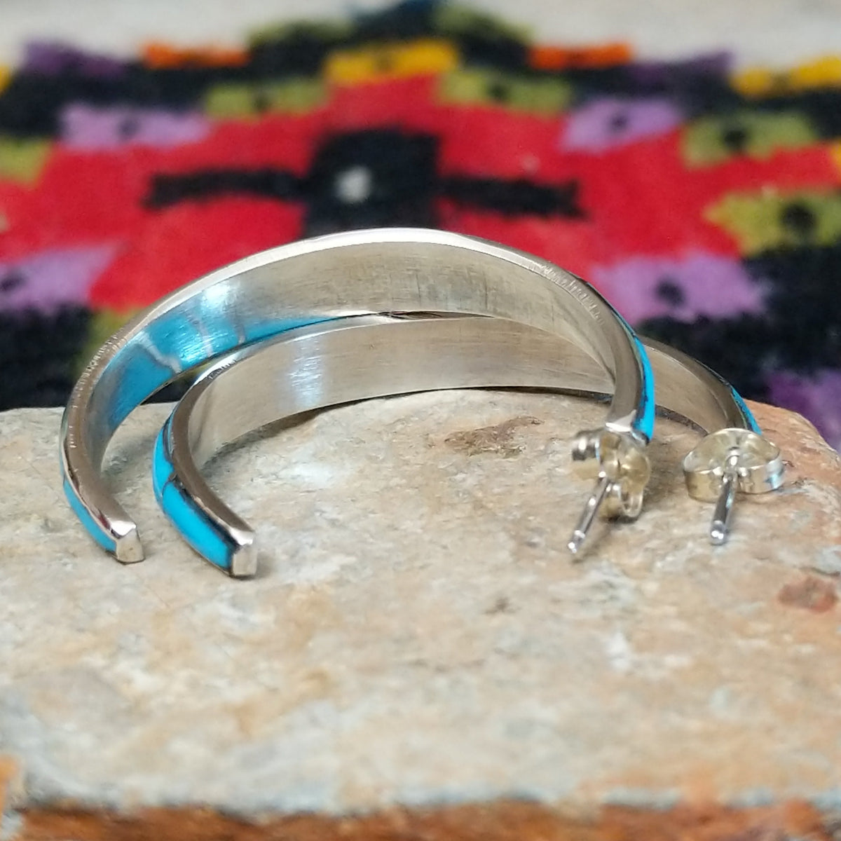Turquoise inlay hoop earrings by Keme Peina with silver line details.