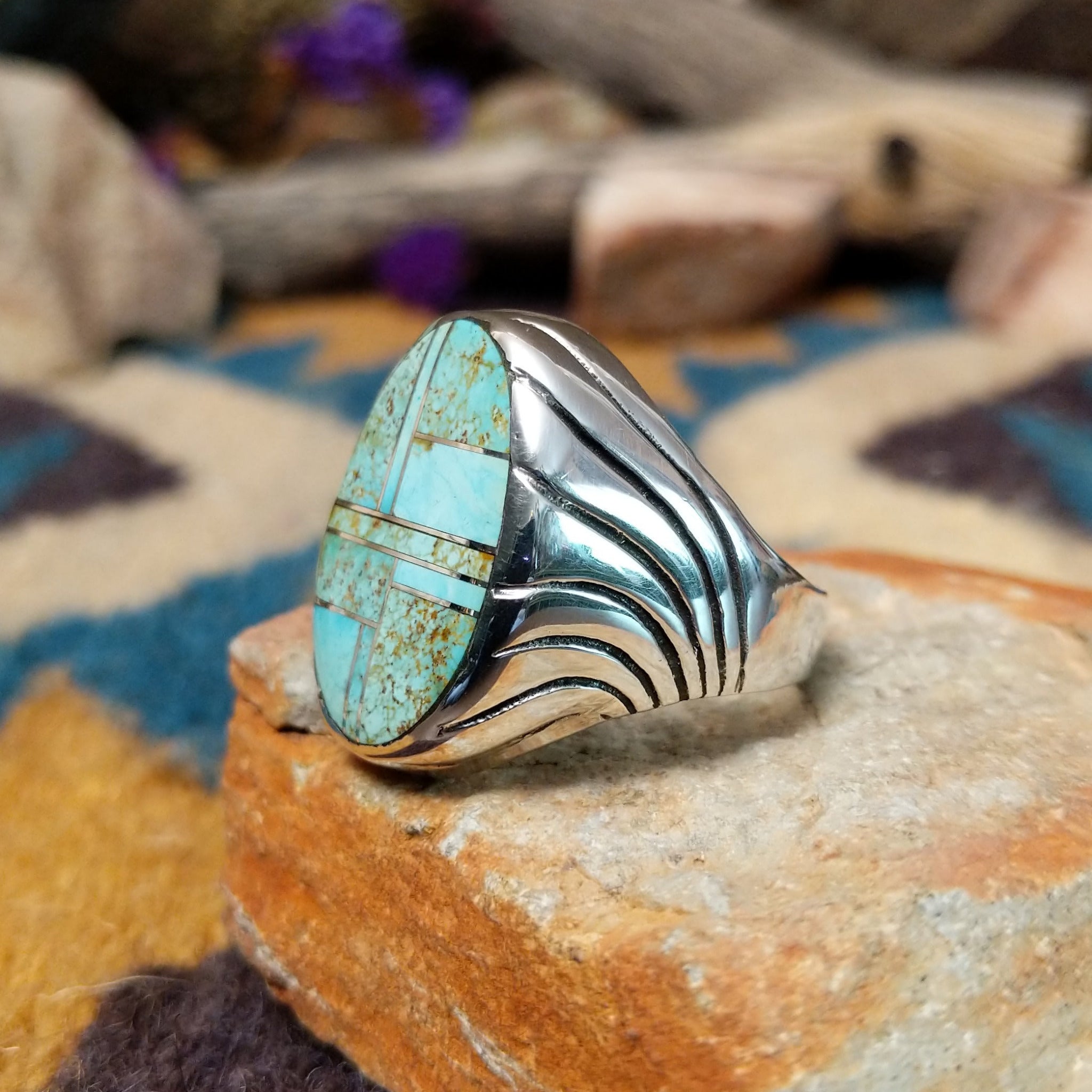 Sterling silver Turquoise inlay ring by Dennis Ramone with an oval geometric mosaic design; side view.