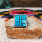 Navajo multistone mosaic shadowbox ring by A.Y. with geometric inlay and rectangular silver frame.