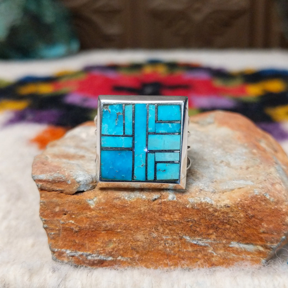 Navajo multistone mosaic shadowbox ring by A.Y. with geometric inlay and rectangular silver frame.