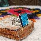Navajo multistone mosaic shadowbox ring by A.Y. with geometric inlay and rectangular silver frame.