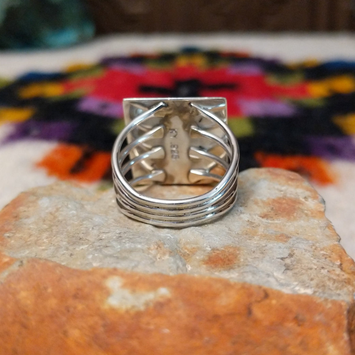 Navajo multistone mosaic shadowbox ring by A.Y. with geometric inlay and rectangular silver frame.
