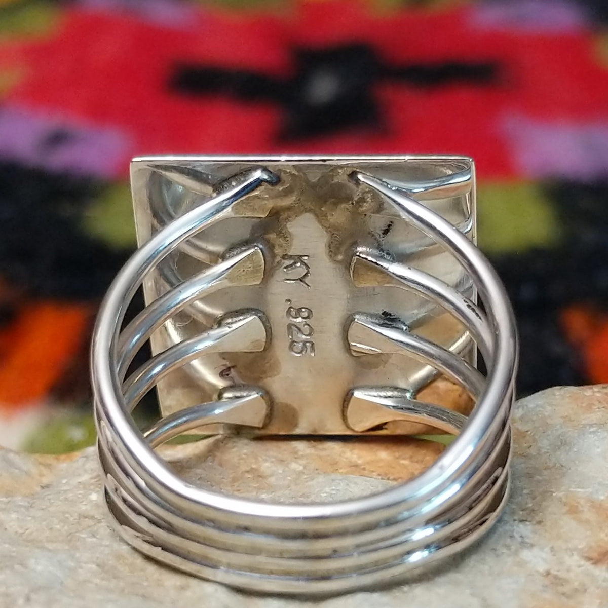 Navajo multistone mosaic shadowbox ring by A.Y. with geometric inlay and rectangular silver frame. Close up of the artist's stamped signature.