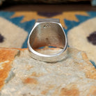 Handcrafted Navajo sterling silver ring by Wilbert Grey featuring a square turquoise mosaic inlay with natural black matrix, set in a polished bezel with a bold geometric design; underside  view.