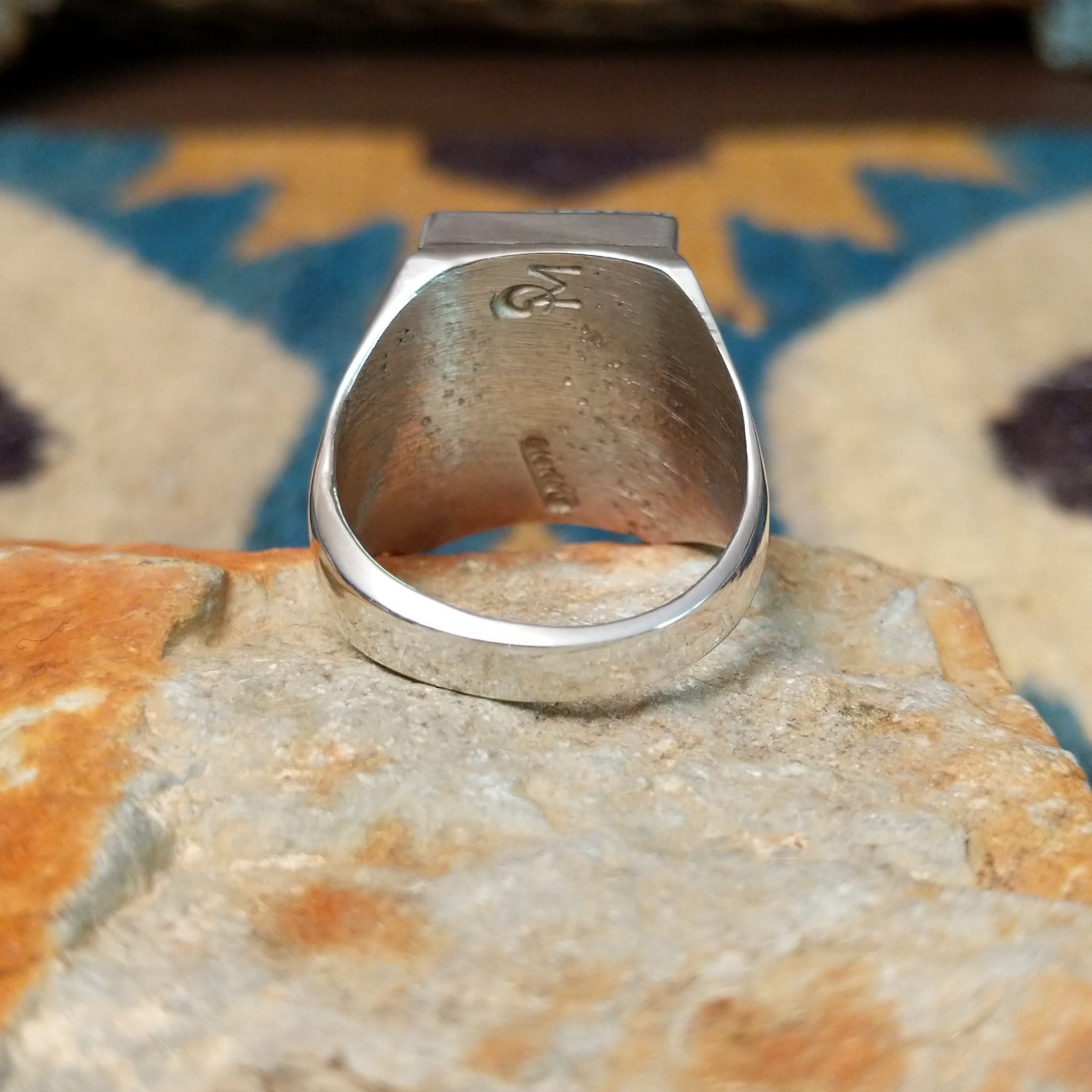 Handcrafted Navajo sterling silver ring by Wilbert Grey featuring a square turquoise mosaic inlay with natural black matrix, set in a polished bezel with a bold geometric design; underside  view.