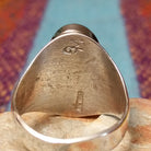 Turquoise Inlay Ring by Wilbert Grey featuring an elongated oval turquoise face with natural matrix, geometric silver channel inlay, and a polished tapered silver band; artisan and Sterling Silver stamp.