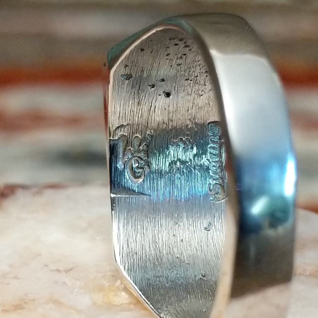 Close-up of the artisan's stamp on the ring.