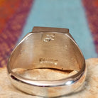 Close up of the artist's stamped signature