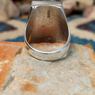 Sterling silver Navajo rectangle ring by Wilbert Grey featuring natural turquoise with black matrix and lapis lazuli geometric inlay in a polished signet-style setting; underside view.