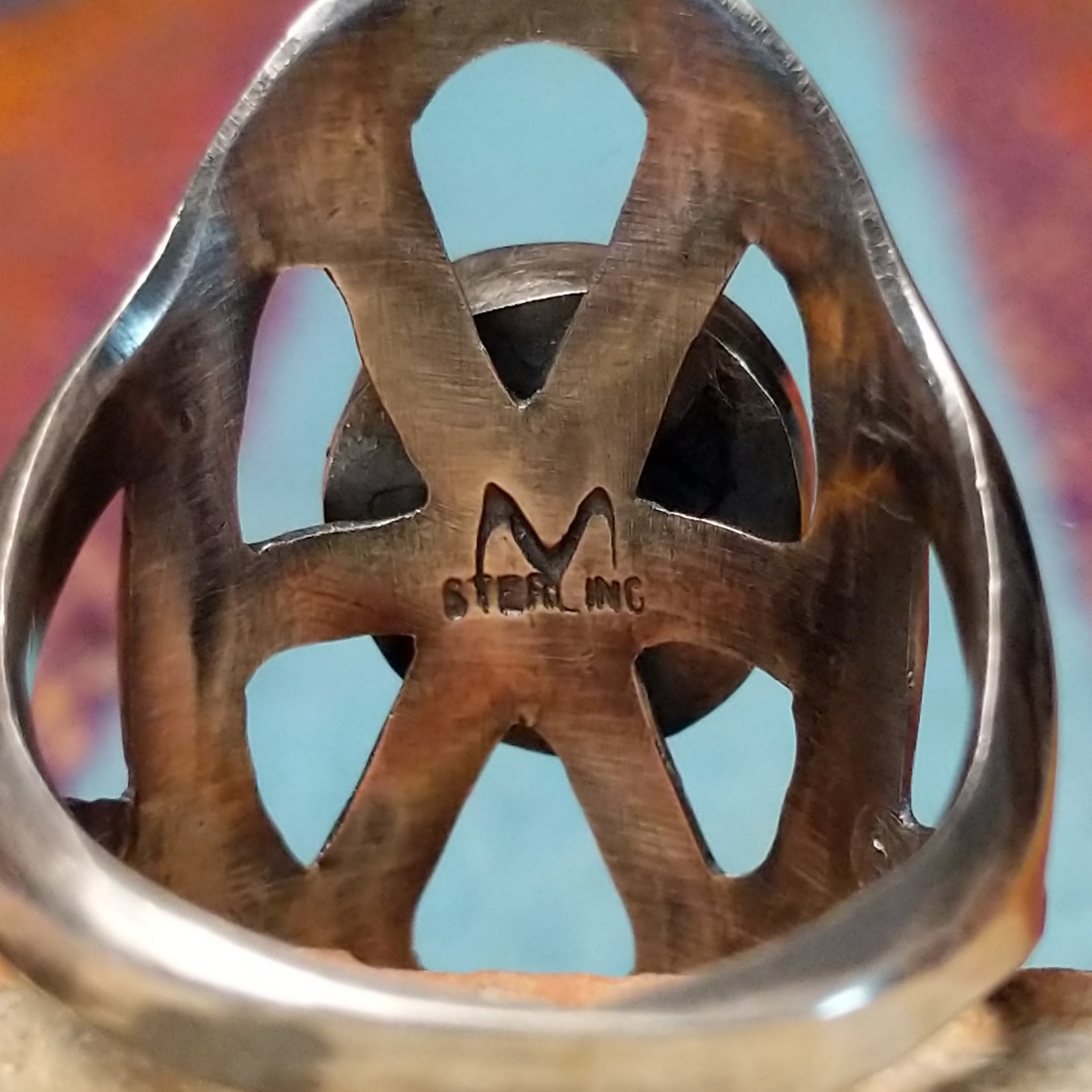 Turquoise Lattice Ring by Harry Morgan featuring an oval turquoise stone with natural matrix set in Sterling Silver, surrounded by bold sculpted lattice-style openwork; artisan and Sterling Silver stamp.